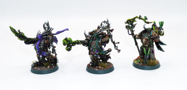 Death Guard trio of Malignant Plaguecasters from the Apostles of Contagion in Warhammer 40,000, showcasing Nurgle psyker miniatures for a Chaos tabletop army.