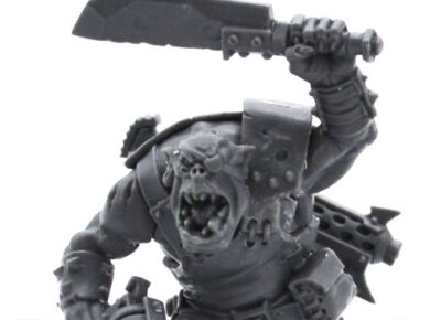 AdeptiCon 2026 promo miniatures featuring an Ork and Space Marine from Warhammer 40,000, showcased in a tabletop wargaming review.